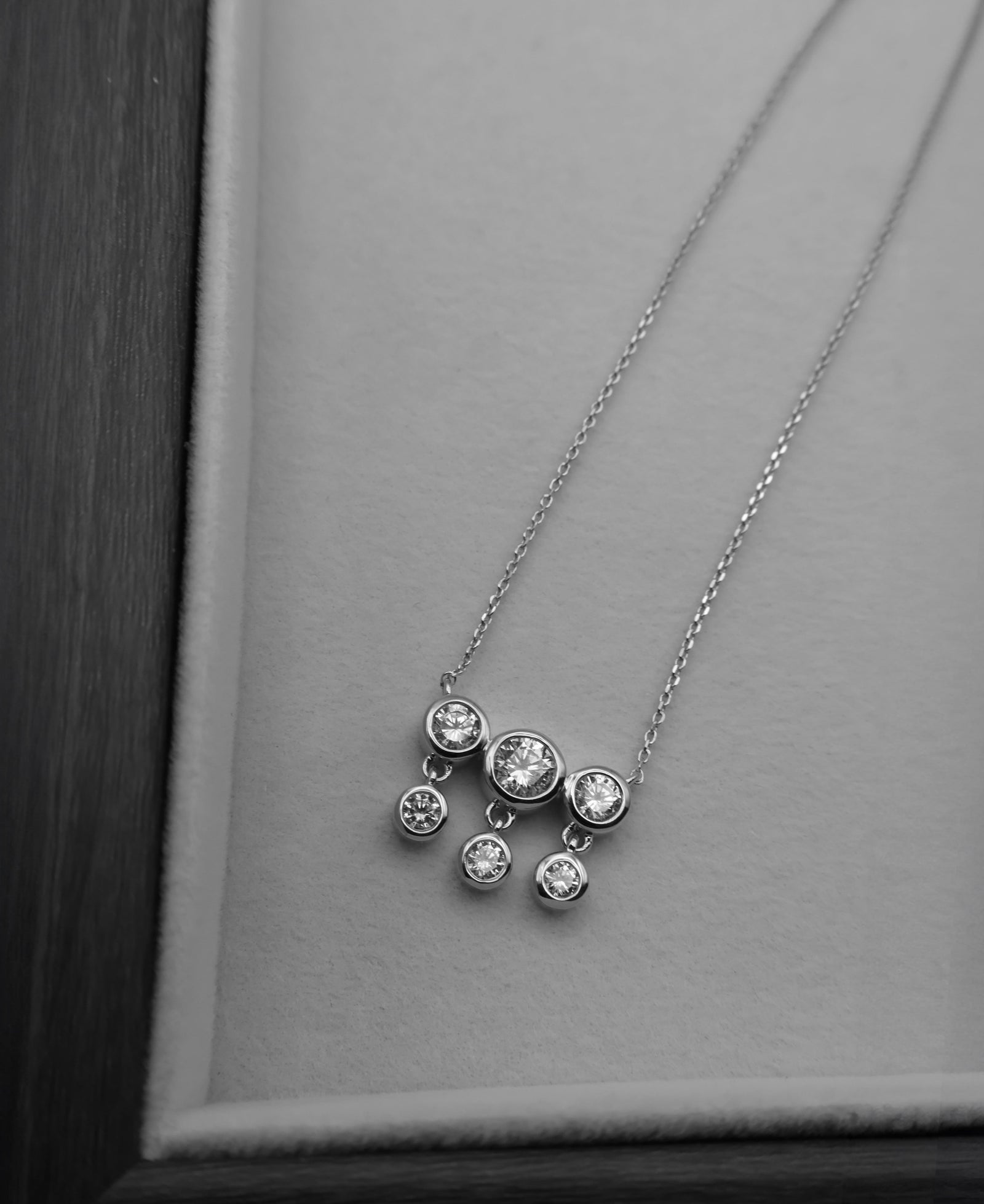 an editorial black and white image gala gulaab's arali necklace crafted in 18k recycled gold vermeil with cubic zironia 